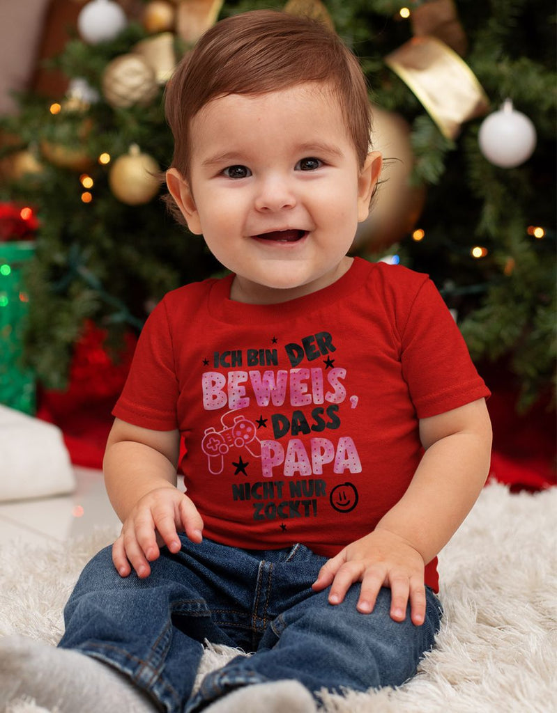 Baby / Kinder T-Shirt kurzarm Ich bin der Beweis, dass Papa nicht nur zockt rosa - von Mikalino